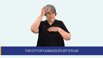 The Auslan video thumbnail for the City of Charles Sturt's Disability Access and Inclusion Plan 2026-2030. A woman in a black shirt and glasses is signing. Below in white text reads, 'The City of Charles Sturt's Plan'.